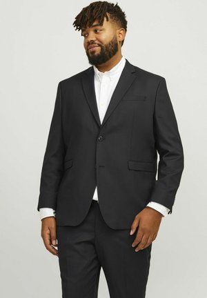 Black tailored suit jacket with a single button, notched lapels, and front pockets. Worn over a white shirt, featuring a clean, modern fit.