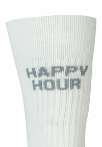 Calza bianca a coste con la scritta "HAPPY HOUR" tessuta in grigio, realizzata con un tessuto testurizzato per comfort e flessibilità.