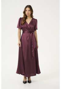 Mauve wrap dress with short puff sleeves, a tied waist sash, and a flowing skirt that reaches the ankles, made from a smooth, shiny fabric.