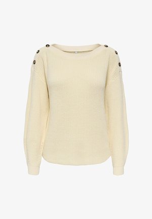 Cream-colored knitted sweater with long sleeves and three dark buttons on each shoulder.