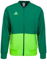 Zelená a neonově zelená bunda Adidas se zipem vpředu, bočními kapsami, žebrovanými manžetami a třemi pruhy na rukávech.