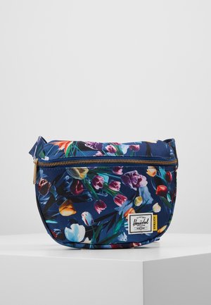 Bolsa con cremallera de color azul marino con estampado floral de vibrantes tulipanes, cremallera dorada y parche rectangular blanco con el logo de Herschel Supply Co. en el frente.