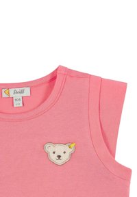 Růžová bezslenová košile z měkké bavlny s kulatým výstřihem a vyšitým obličejem medvěda na přední straně. Velikostní štítek uvádí 104 (3-4 roky).