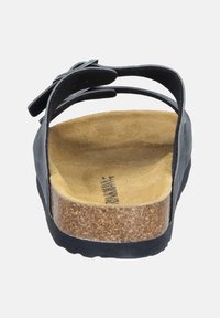 Black sandal with a cork footbed, textured suede insole, dual straps, and decorative bow detail. Flexible rubber sole for comfort.