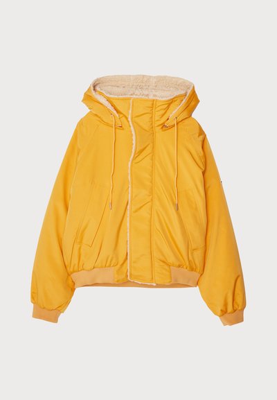 Yellow puffer jacket with a faux fur-lined hood, front zip closure, and two large side pockets. Cuffs and hem are elasticized.