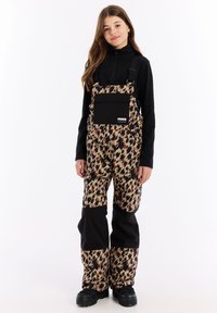 Salopette con stampa leopardata e dettagli neri, dotata di tasca sul petto. Realizzata in un materiale testurizzato. Caratterizzata da spalline regolabili e vestibilità ampia.