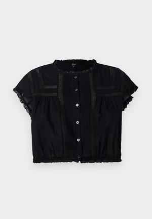 Svart kortermet topp med lace-detaljer, knappåpning foran og plisserte detaljer på bodice og ermer.