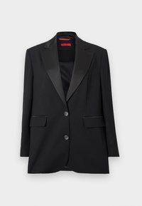 Zwarte blazer met satijnen revers, éénknops sluiting, twee voorzakken en een gladde textuur. Rode binnenlabel zichtbaar.