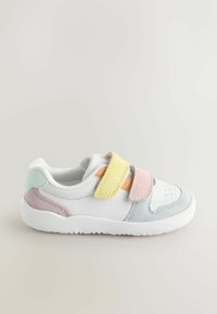 White sneaker with pastel accents in yellow, pink, blue, and lavender. Features Velcro straps, a textured finish, and perforated detailing.