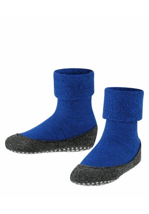 Calze di lana blu con risvolto, dotate di una suola in feltro grigia e una superficie testurizzata, decorate con punti bianchi antiscivolo sulla parte inferiore.