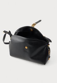 Black leather handbag with a structured shape, golden hardware accents, magnetic closure, and adjustable strap. Interior features one pocket.
