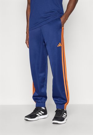 STADIUM - Träningsbyxor - dark blue/pure orange