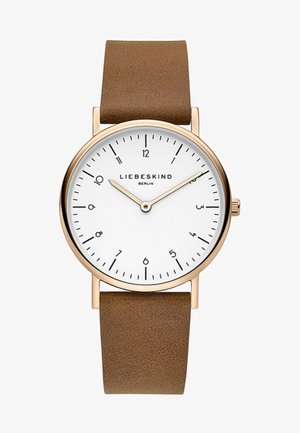 Montre avec bracelet en cuir marron, cadran blanc, boîtier doré, marqueurs d'heure noirs et aiguilles argentées. Nom de la marque "LIEBESKIND" affiché.