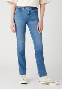 Ljusblå denimjeans med slim fit, featuring en mid-waist design, traditionell femficksdesign och knappgylf.