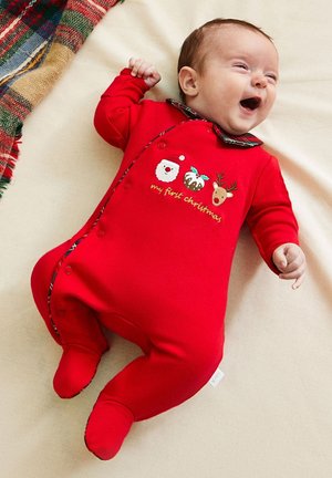 Punane puuvillast bodi pikkade varrukatega, nööbikinnitus ja pidulik tikand, mis kujutab Jõuluvana, pudingit ja põhjapõdra, plüüsist kraega.