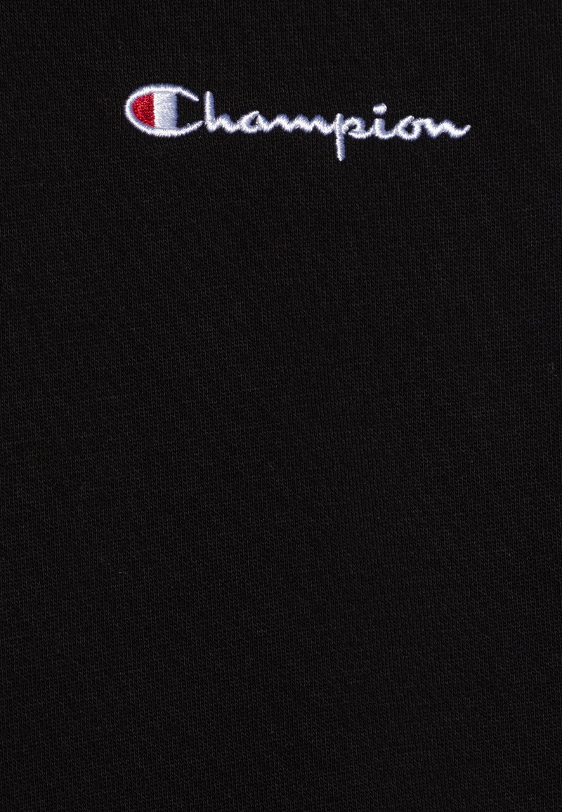Czarny bawełniany T-shirt o miękkiej teksturze, z białym haftowanym logotypem "Champion" oraz czerwonym akcentem na literze "C". Prosty i elegancki design.
