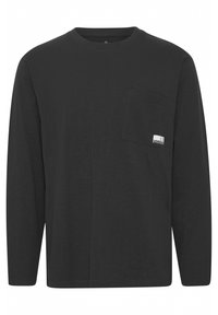 Long-sleeve black t-shirt made from soft fabric with a crew neckline and a chest pocket featuring a small logo label.