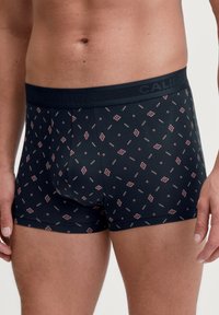 Fitted black boxer briefs with a patterned design in red and cream. Features a branded elastic waistband for secure fit. Soft material.