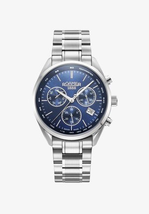 Ruostumattomasta teräksestä valmistettu rannekello sinisellä kellotaululla, hopeanväriset tuntimerkit, chronograph-toiminnot ja päivämääränäyttö. Varustettu kiillotetulla metallirannekkeella.