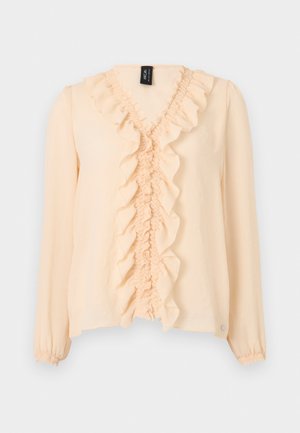 Long-sleeve beige blouse with ruffled V-neckline and front, elastic cuffs, and lightweight fabric.
