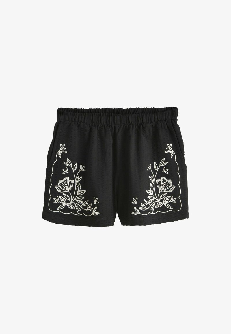 Shorts noirs avec broderie florale blanche sur les côtés, taille élastique et tissu texturé avec une coupe ample.
