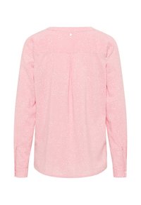 Langärmlige Bluse in Hellrosa mit dezentem weißen Punktmuster. Sie hat einen runden Ausschnitt und eine Rückenfalte. Mit Knopfmanschettenakzenten.