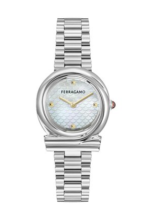 Silver Ferragamo wristwatch with scalloped white face, gold hour markers and hands, and a linked metal band.