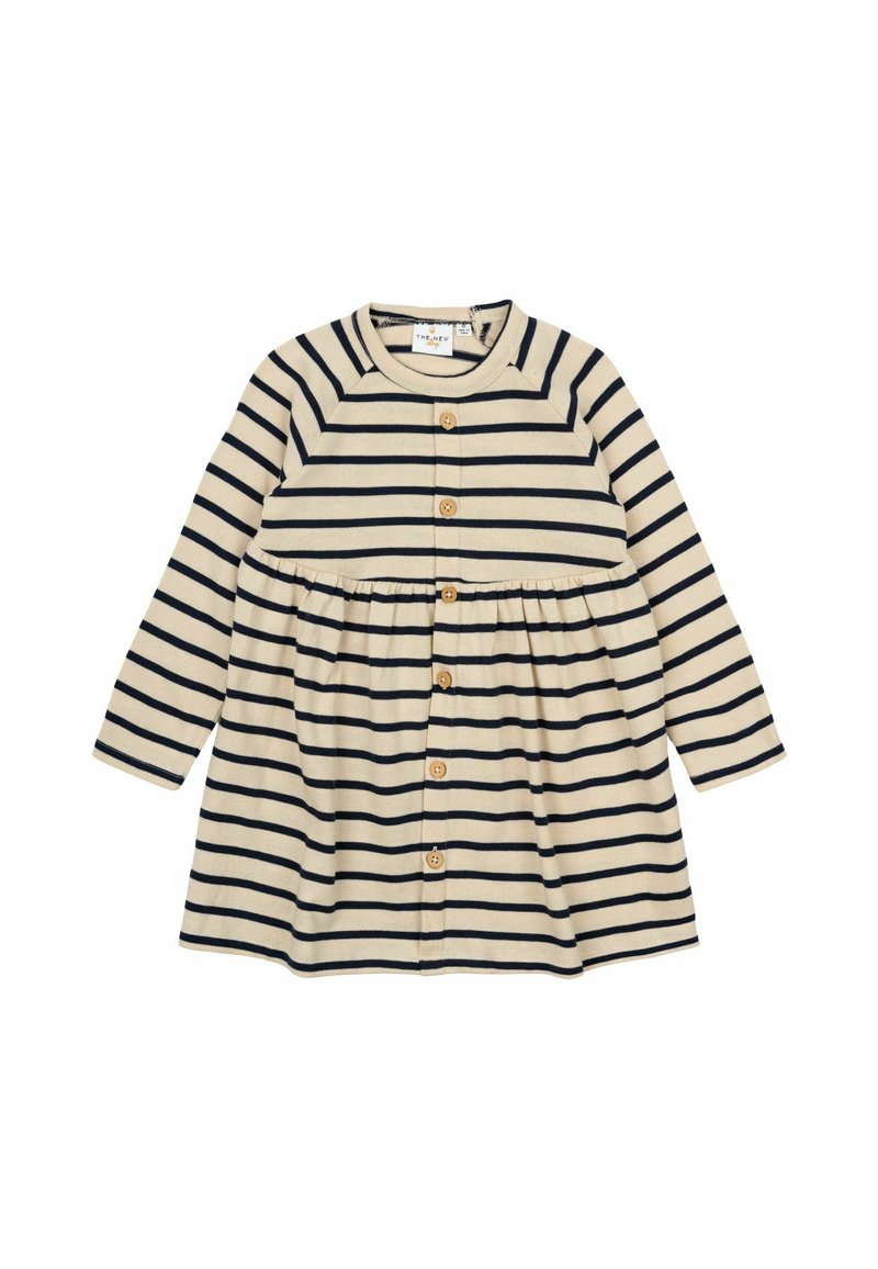 Ilgų rankovių smėlio spalvos su tamsiai mėlynomis horizontaliomis juostelėmis suknelė, turi apvalų iškirpimą, mygtukų užsegimą ir susirinkusį liemenį, kuris suteikia platų siluetą.