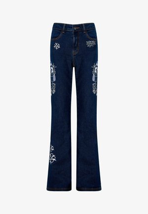 Mørkeblå flarebukser med broderede blomsterdesigns på lårene og nederste ben. Har kobberfarvede syninger og en frontknaplukning.