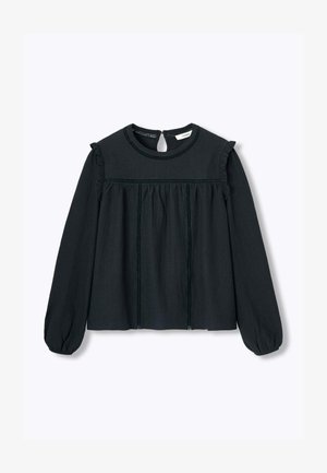 Haut noir à manches longues avec un col rond, des accents à volants sur les épaules et un tissu texturé présentant des coutures verticales et une ouverture arrière.