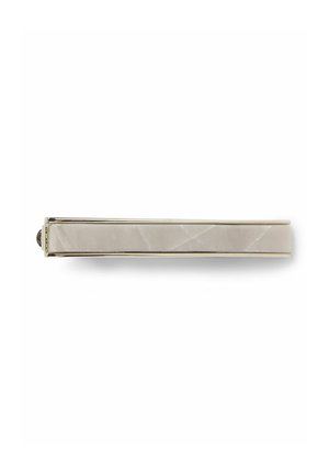 Metal hair clip with a sleek, elongated design, featuring a smooth, pale beige stone inlay and a polished metallic edge.