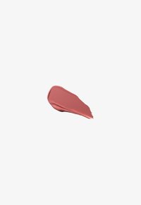 Étirement lisse de rouge à lèvres rose doux à la texture crémeuse sur un fond blanc uni.