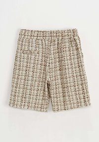 Shorts en tweed crème et marron, dotés d'un motif à carreaux, d'une taille élastique et de poches latérales. La texture semble tissée et douce.