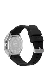 Reloj con correa de silicona negra y caja octagonal de acero inoxidable plateado. Presenta una textura suave y un fondo de acero inoxidable marcado como 'ice watch'.