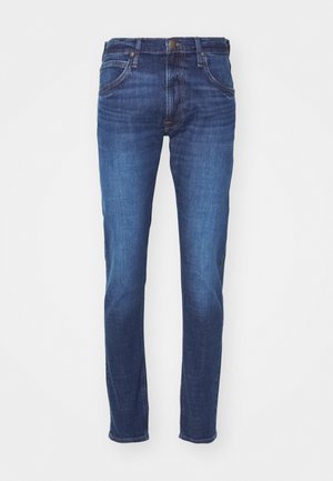 Blå denimjeans med slim fit, femficksdesign och subtil blekning. Har detaljer i guldton och stickningar.