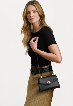 Black leather handbag with a structured design, gold hardware, and a top handle. Features a detachable shoulder strap and logo accent.
