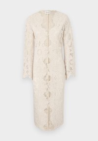 Lace dress in off-white with long sleeves, a v-neck, and a center front opening. Features intricate floral patterns and scalloped edges.