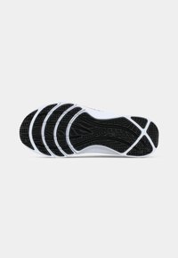 Shoe sole with black textured grip and white accents, designed for traction and support, shown against a plain light background.