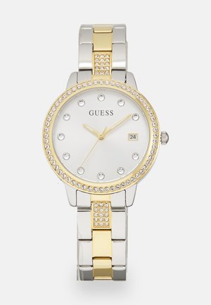 Silver and gold metal watch with a round face, crystal accents, white dial, and date display. Features link bracelet design.