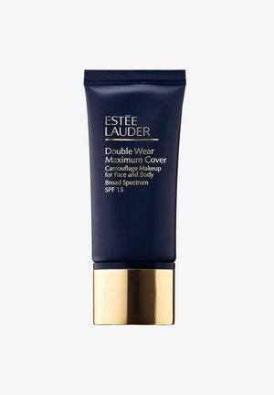 Tubo azul marino con banda dorada, etiquetado como "Double Wear Maximum Cover." Contiene maquillaje de camuflaje para rostro y cuerpo, SPF 15.