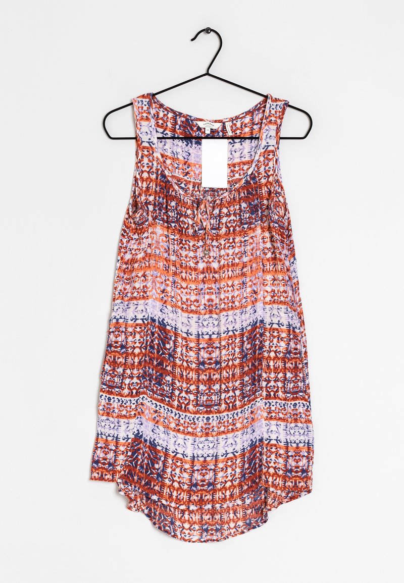 Sleeveless women's blouse with red, white, and blue geometric patterns, round neckline, hanging on a black clothes hanger against a white background.