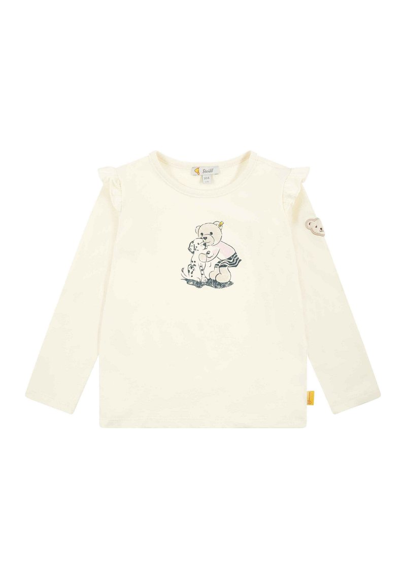 Camicia a maniche lunghe color crema con dettagli arricciati sulle spalle. Presenta un design stampato di un orso e un cane. Include un patch a forma di orso sulla manica.