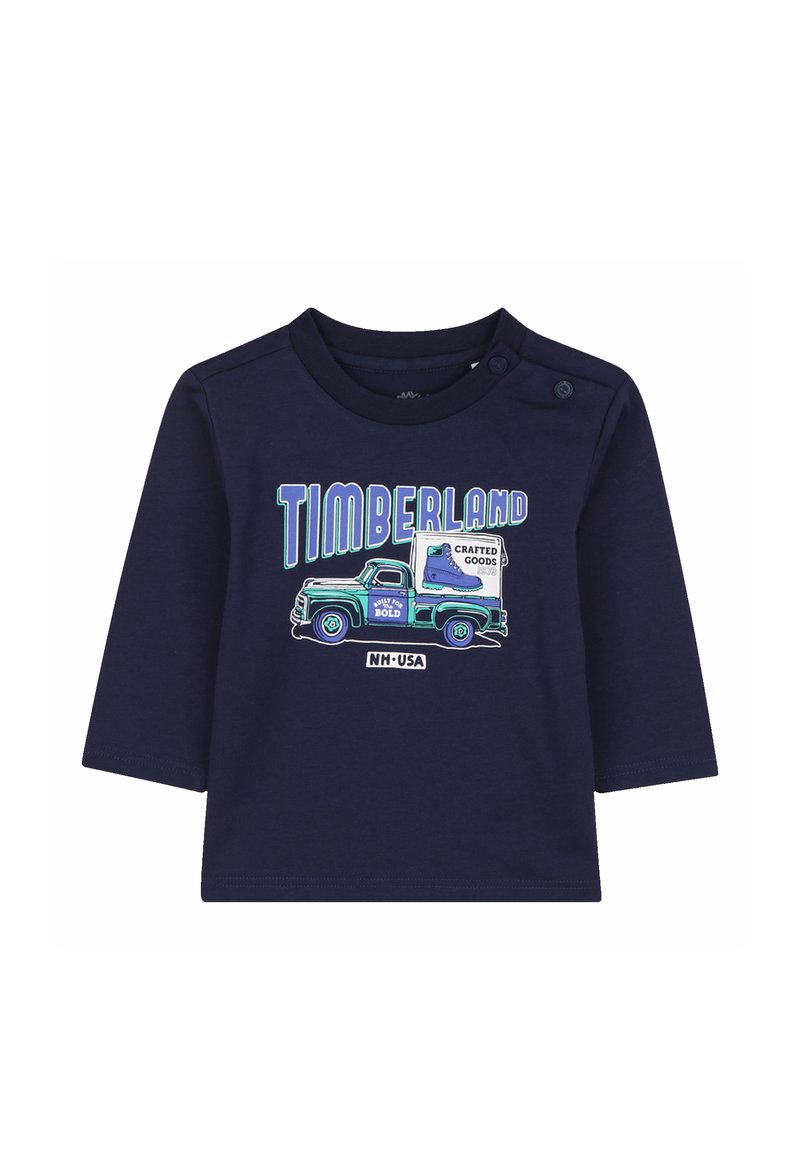 Granatowa koszula z długim rękawem z grafiką vintage ciężarówki i napisem "TIMBERLAND" w niebieskim i zielonym kolorze. Wykonana z miękkiego bawełnianego materiału z zapięciem na zatrzaski.