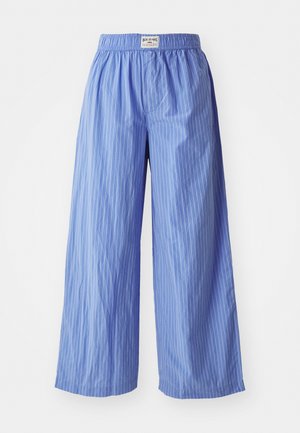 Wide-leg pants in light blue with vertical white stripes. Features an elastic waistband and smooth fabric texture.