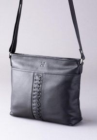 Black leather shoulder bag with a textured braided accent down the center. Features a detachable strap and silver-toned hardware.