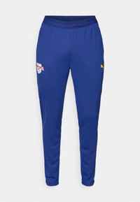 Pantaloni sportivi albaștri dintr-un material ușor, cu un brâu elastic, buzunare laterale și logouri cu accente albe și galbene.