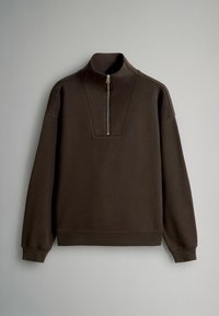 Mørkebrun pullover sweatshirt med høj krave, halv lynlås foran og ribbede manchetter og kant. Blødt stof med en struktureret overflade.