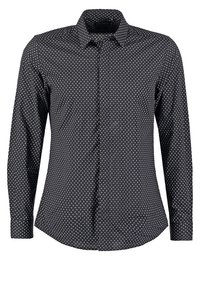 Maglietta nera a maniche lunghe con motivo a diamante bianco, chiusura a bottoni davanti, colletto e orlo curvo. Realizzata in tessuto leggero con una consistenza liscia.