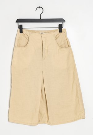 Beige wijde broek van zachte stof, met twee voorzakken, een ritssluiting aan de voorkant en een strak, schoon ontwerp zonder patronen.