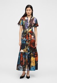 Floral print maxi dress featuring short sleeves, a cinched waist with a bow, and a tiered bottom in shades of blue, red, and yellow.